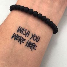 a wrist tattoo with the words wish you were here written on it