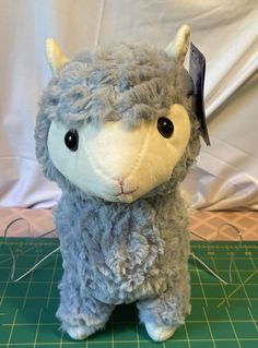 This adorable Kellytoy Llama plush is perfect for any animal lover! With its soft and cuddly material, this small (6-14 in) stuffed animal is sure to become a beloved companion. The light blue-gray color and sweet expression make it a great addition to any collection, and it's surface washable for easy cleaning. This 2019 plush is made by Kellytoy and is of high quality. It's suitable for any occasion and recommended for ages 3 and up. This Llama plush has a tag and is part of the Llama character family. Get your hands on this cute stuffed animal today! Animal Light, Sweet Expression, Llama Plush, Llama Alpaca, Llama, Stuffed Animal, Blue Gray, Easy Cleaning