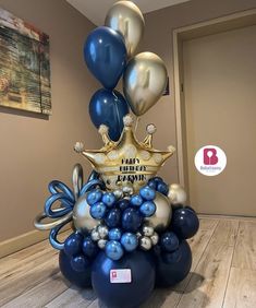 blue and silver balloons are stacked on top of each other in the shape of a crown