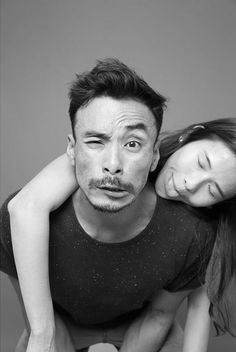 a man and woman are posing for a black and white photo with their arms around each other