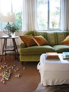 a living room filled with furniture and lots of clutter on the floor next to a window