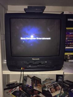 an old television with the sony computer entertainment logo on it's display shelf in a store