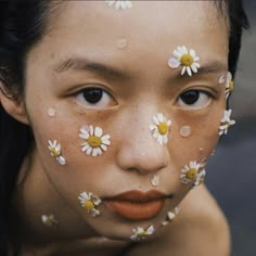 a woman with flowers painted on her face