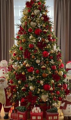 a christmas tree decorated with red and gold ornaments