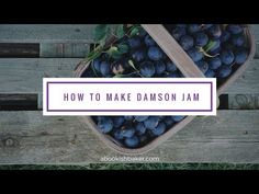 a basket filled with blue plums sitting on top of a wooden table next to a sign that says how to make diamond jam