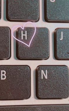 a computer keyboard with a heart on it