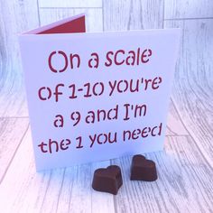 a card with chocolates in front of it that says on a scale of 120 you're a 9 and i'm the 1 you need