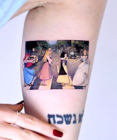 a woman's arm with an image of disney characters on it