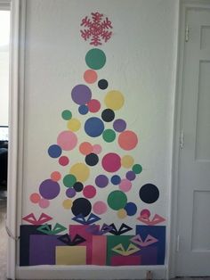 a decorated christmas tree on the wall in a room with white walls and flooring