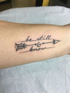 a person with a tattoo on their arm that says, be still and know in cursive writing