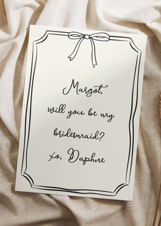 a card that says, mergat will you be my bridesmaid to do something?