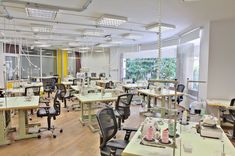 a room filled with lots of desks and chairs