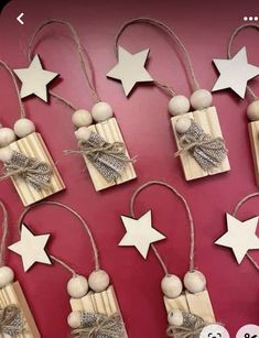 several wooden ornaments are hanging on the wall with string and star decorations attached to them