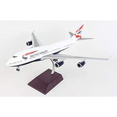 a model airplane on a white surface with a black base and red trimmings