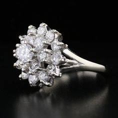 Description:An exquisite vintage diamond cluster ring in 14K white gold, weighing 5.3 grams. This captivating piece features a dazzling array of round diamonds with G-H color and SI1 clarity. The center diamond weighs 0.36ct, surrounded by 18 smaller round diamonds, totaling 1.62 carats, creating a stunning 1.98ct total diamond weight. The intricate cluster design sparkles with elegance, making this ring a brilliant addition to any collection. Specifications: Metal: 14K White Gold Weight: 5.3 gr Groom Accessories, Bridal Bands, Diamond Cluster Ring, Diamond Cluster, Chain Earrings, Cluster Ring, Vintage Diamond, Bridal Rings, White Gold Diamonds