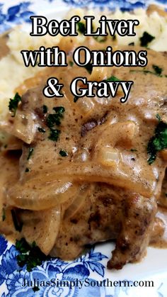 beef livers with onions and gravy on a blue and white floral plate