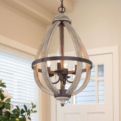 Featuring refined design in weathered oak wood and antique forged iron artisan finish offers rustic flair in an iconic long oval silhouette. Something about the vintage, weathered look alludes to simpler times, but the crisp edges and bold lines with open frames bring us back to a more modern style. This neutral ambient light fixture provides comfort with elegance to your dining room, kitchen, or hallway. LNC Quaint 4-Light Distressed Gray Farmhouse Led Cage WoodChandelier | QNZMV2LWS388557 Rustic Wood Lanterns, Candlestick Chandelier, Cage Chandelier, Wood Lantern, Lantern Chandelier, Wood Chandelier, Farmhouse Chandelier, Geometric Chandelier, Drum Chandelier