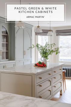 a white kitchen with marble counter tops and cabinets in the background is an image of a vase filled with flowers