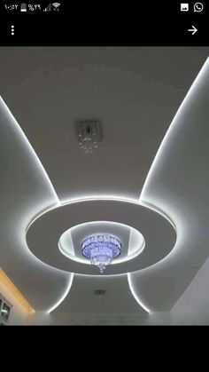 an image of a ceiling with lights in the middle and circular design on the ceiling