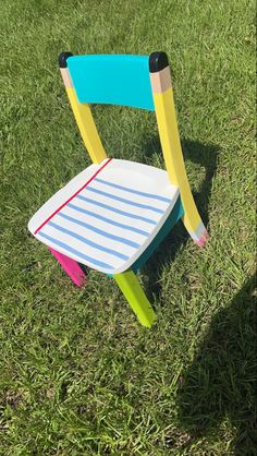 a plastic chair sitting on top of a lush green field