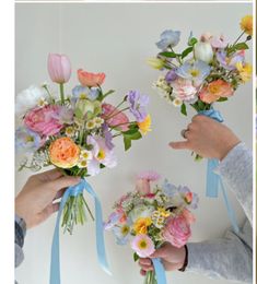 three different pictures of flowers being held by hands with ribbons around them and the same bouquet