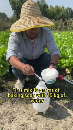 a man in a straw hat is filling water into a container