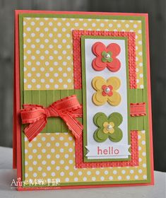 a close up of a greeting card with flowers and ribbons on the front, along with polka dots