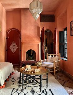 a living room filled with furniture and a fire place next to a bed on top of a rug