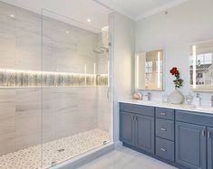 a large bathroom with two sinks and a walk in shower