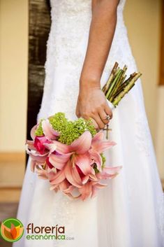 a bride holding a bouquet of flowers in her hand