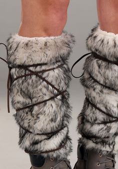 the legs and ankles of a woman wearing boots with fur on them, tied together