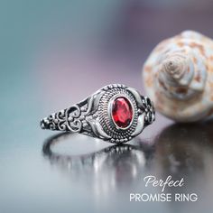 This Unique Graduation Ring features an 7 x 5 mm oval Red Cubic Zirconia (approx. 1.5 cts). This stone is securely set in a Rhodium Plated Sterling Silver mounting. This scratch resistant coating helps keep your silver bright and shiny! This diamond alternative promise ring measures 14 mm at its widest point and stands 11 mm in height. The band measures 3 mm in width. This ring is available in US Ring half sizes from 4 - 10.5 while supplies last. This elegant ring would make a great engagement r Oval Ruby Ring With Vs Clarity For Anniversary, Oval Vs Clarity Birthstone Promise Ring, Oval Ruby Crystal Promise Ring, Oval Ruby Crystal Ring As Gift, Ruby Ring With Oval Cabochon Center Stone For Gift, Sterling Silver Oval Crystal Promise Ring, Sterling Silver Red Ring For Promise, Oval Crystal Ring With Vs Clarity For Gift, Classic Oval Crystal Promise Ring