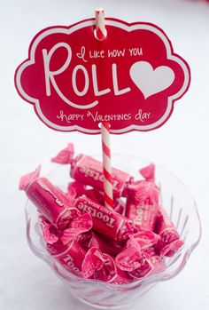 valentine's day candy in a glass bowl with a sign on top that says i like how you roll