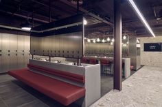 an empty locker room with benches and sinks