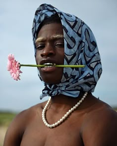 a woman with a flower in her mouth