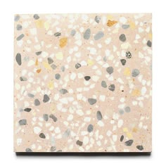 a square tile with different colored pebbles on it