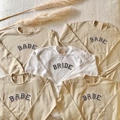 four bride shirts with the word babe on them are laid out next to each other