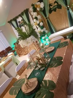 the table is set with gold and green decorations