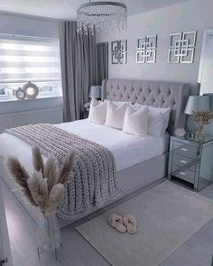 a bedroom with a large bed and chandelier