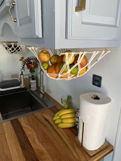 a kitchen counter with some fruit on top of it and a roll of toilet paper