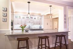 a kitchen with two stools and an island