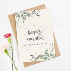 a card that says happily ever after on your wedding day next to some pink flowers