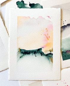 some watercolors are laying on top of each other