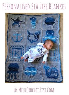 a baby laying on top of a blue crocheted blanket with an ocean theme