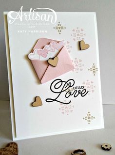 a card with some hearts on it and the words love is in front of it