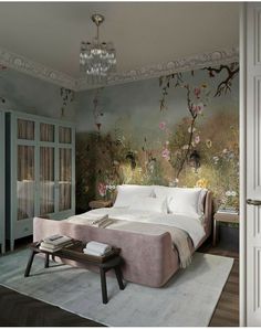 a bedroom with floral wallpaper and chandelier hanging from the ceiling, along with a large bed