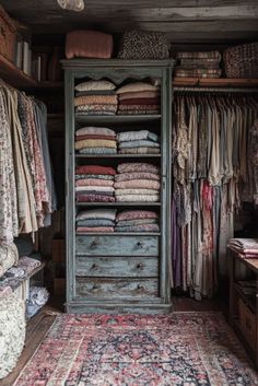 an old closet is full of clothes and rugs in the corner, with drawers on either side