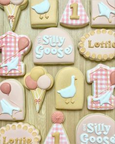 decorated cookies are displayed on a table for someone's 1st birthday party or baby shower