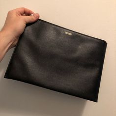 In Great Shape Designer Black Top Handle Pouch, Luxury Black Top Handle Pouch, Classic Rectangular Office Pouch, Designer Top Handle Formal Pouch, Formal Top Handle Pouch With Dust Bag, Black Leather Top Handle Pouch, Designer Black Leather Pouch, Black Textured Leather Pouch, Black Soft Leather Pouch For Business