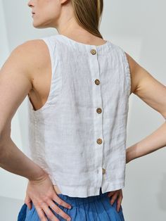 "Crop linen top buttoned at the back. Cropped length and large arm cutouts gives this sleeveless tank top lots of youthfulness while button fastening at the back and decorative hems turn this linen blouse into a solid preppy piece. No doubt, this crew-neck top would blend perfectly into almost any outfit. We boldly call it a must-have item for a woman on any age or style.  STYLE DETAILS * Regular fit * Crew neck * Large arm cutouts * Button fastening at the back * Crop length * French seams insi Sleeveless Summer Tops With Button Back, Sleeveless Button Back Tops For Summer, Sleeveless Spring Top With Button Back, Spring Sleeveless Top With Button Back, Sleeveless Tops With Button Back For Spring, Sleeveless Button Back Top For Spring, Fitted Linen Tank Top For Everyday, Everyday Sleeveless Linen Top, Sleeveless Tops With Buttons For Everyday